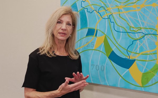 Sabre Esler stands next to her painting in the Georgia Experience Center