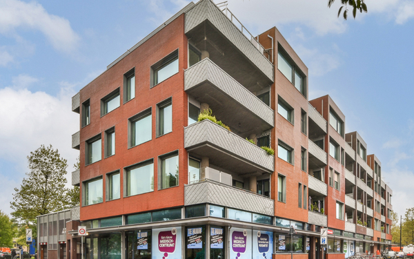 Vacant corner building with retail options on ground level and housing above